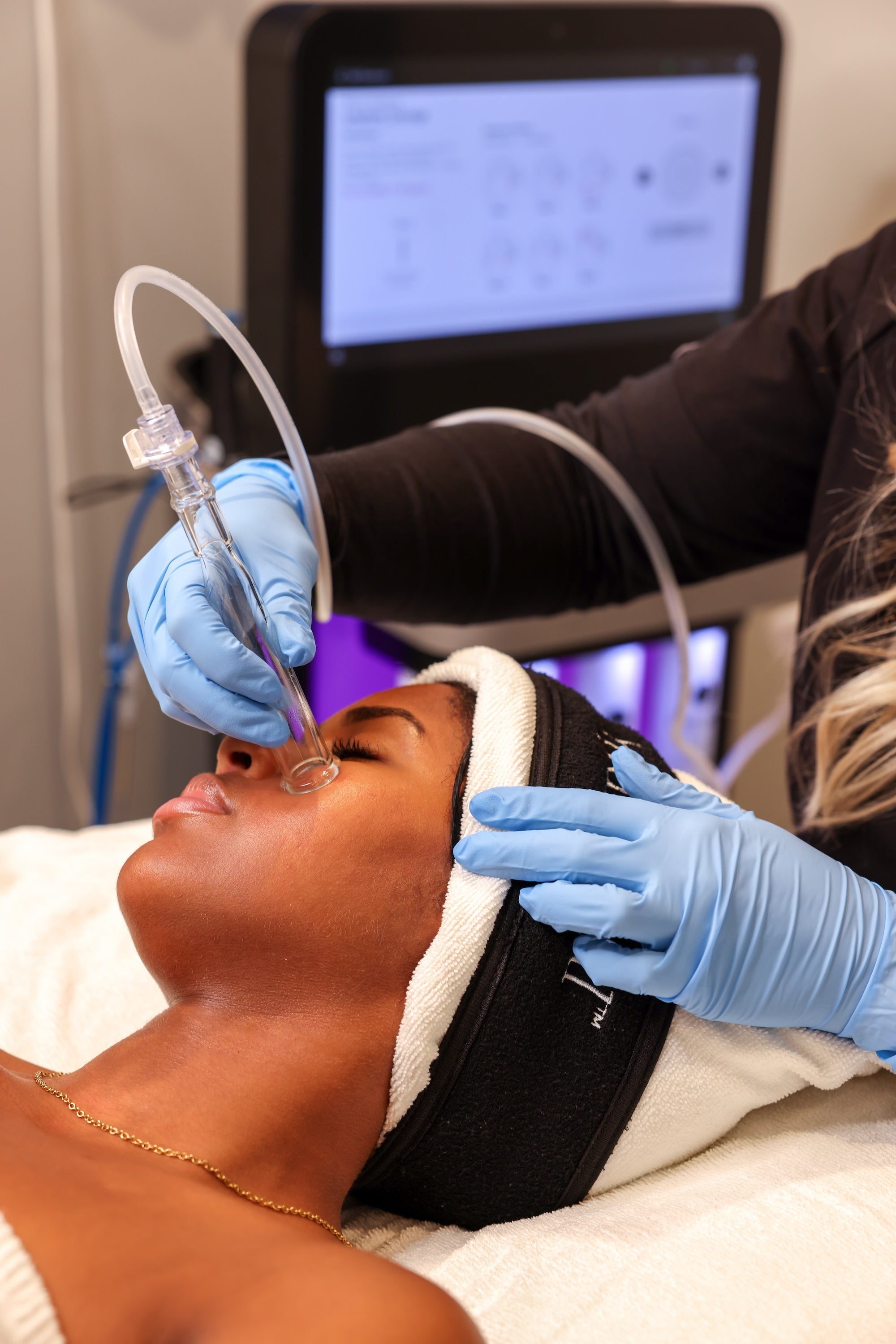 hydrafacial treatment with instrument on patient's face