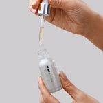 iS Clinical Brightening Serum, hand holding the dropper