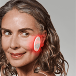 Omnilux Skin Corrector, model holding the device to the cheek