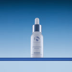 iS Clinical Brightening Serum, bottle on blue background