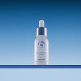 iS Clinical Brightening Serum, bottle on blue background