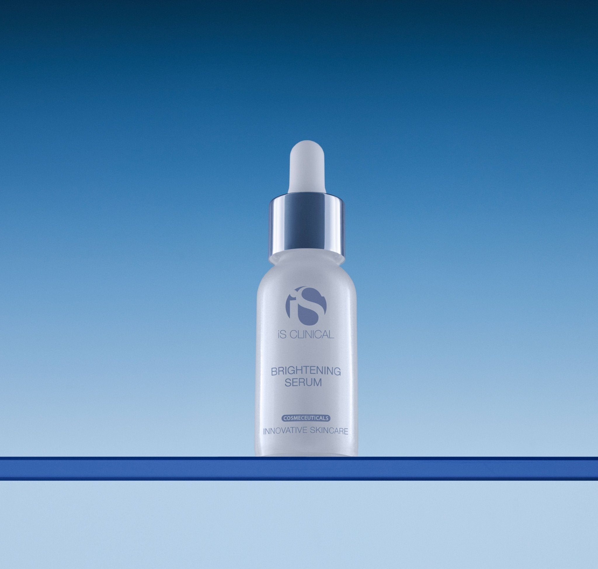 iS Clinical Brightening Serum, bottle on blue background